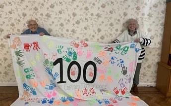 Residents of Downing House placed 100 handprints on a sheet to mark and remember the occasion Image