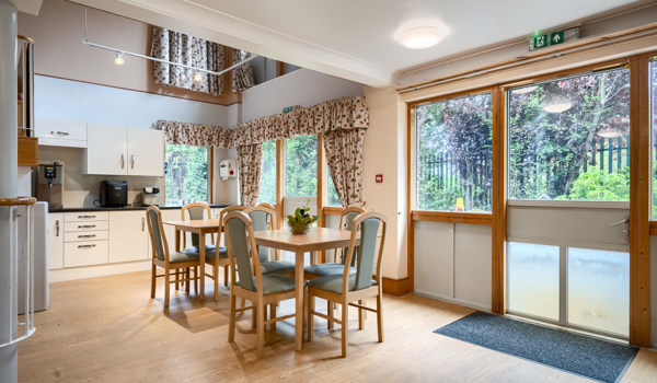 Cafeteria with table and chairs at Abbeyfield House, New Malden
