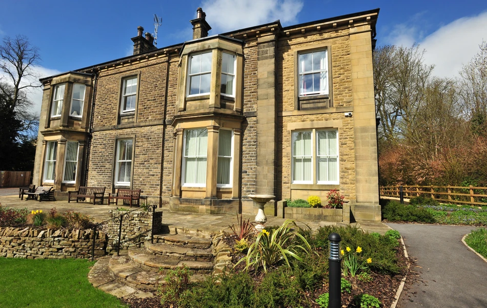 Full view of the house with stone steps into the garden