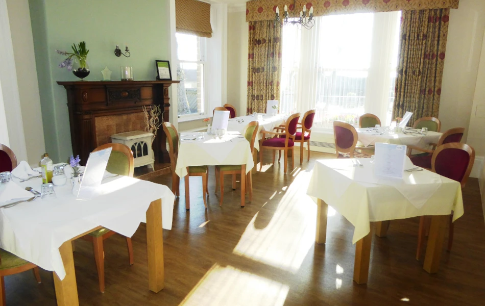 Residents dining area with tables set for dinner