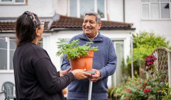 Older Man And Woman Laughing In The Garden Together